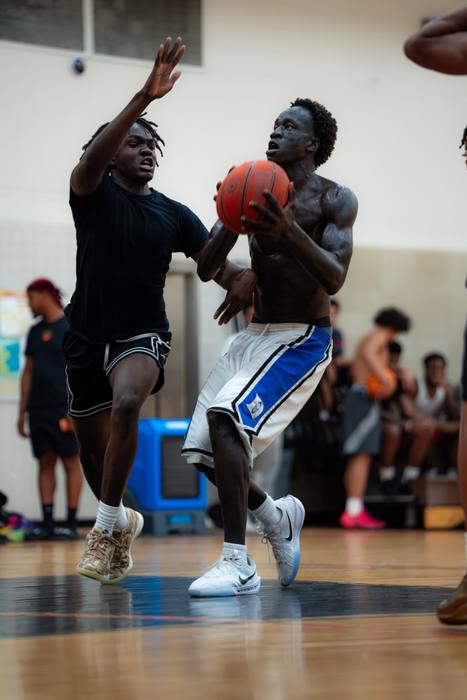Player driving through contact toward the basket