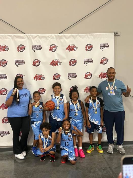 Chase Elite youth team with medals in front of a tournament backdrop